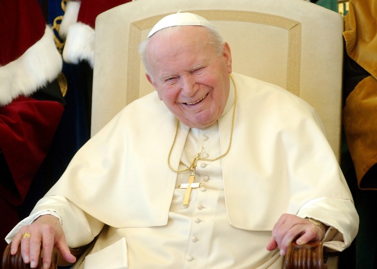 Pope John Paul II  breaks into a long laugh at the Vatican in this Feb. 17, 2004 file photo.