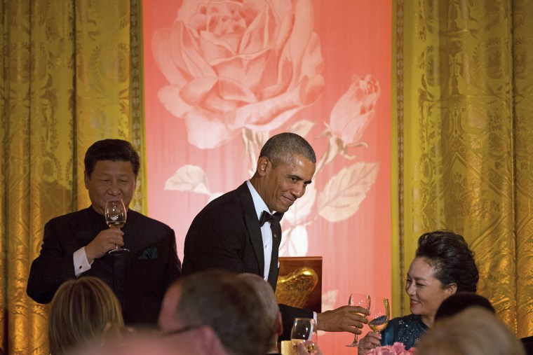 President Barack Obama, accompanied by Chinese President Xi Jinping, left, toasts his wife Peng Liyuan, right, during a State Dinner, Sept. 25, 2015, in the East Room of the White House. (Photo by Andrew Harnik/AP)