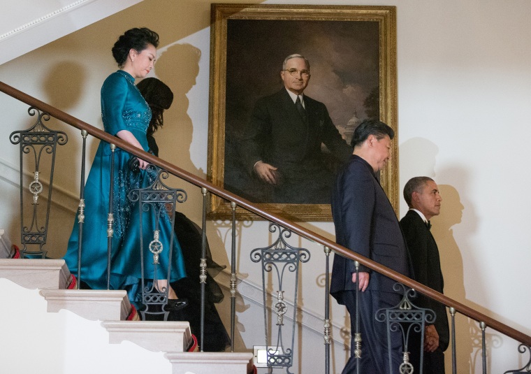 President Barack Obama, Chinese President Xi Jinping, first lady Michelle Obama and Jinping's wife Peng Liyuan descend the Grand Staircase as they arrive for a State Dinner, Sept. 25, 2015. (Photo by Andrew Harnik/AP)