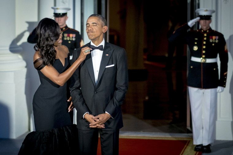 Michelle Obama adjusts President Obama's bow-tie prior to greeting Xi Jinping, China's president, and Peng Liyuan, China's first lady, both not pictured, on the North Portico of the White House, Sept. 25, 2015. (Photo by Pete Marovich/Bloomberg/Getty)