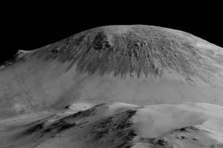 A handout image made available by NASA on Sept. 27, 2015, shows dark, narrow, 100 meter-long streaks called recurring slope lineae flowing downhill on Mars are inferred to have been formed by contemporary flowing water.