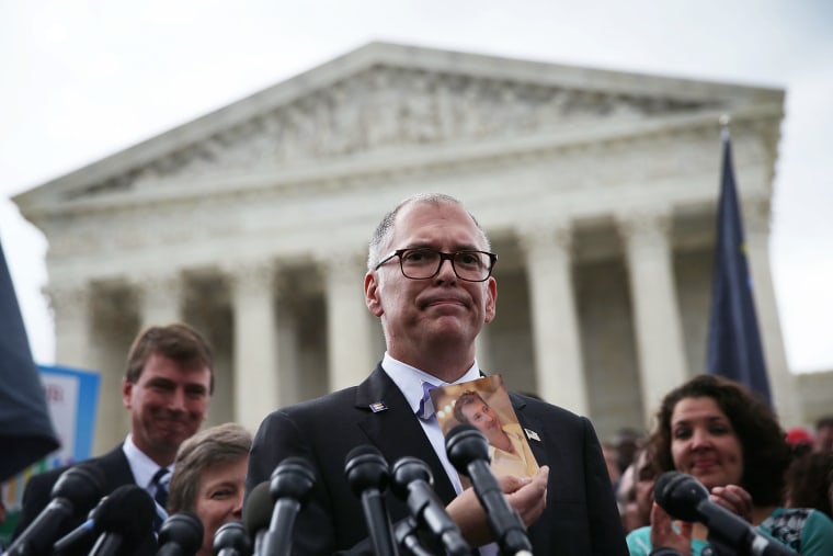 Plaintiff Jim Obergefell holds a photo of his late husband John Arthur as he speaks to the media after the U.S. Supreme Court ruled in favor of same-sex marriage, June 26, 2015, in Washington, DC. (Photo by Alex Wong/Getty)
