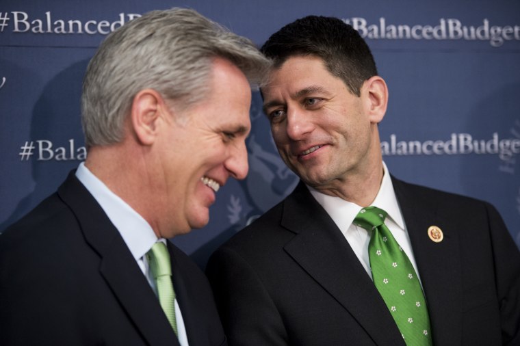 House Budget Committee chairman Paul Ryan whispers to House Majority Whip Kevin McCarthy during the House Republican leadership media availability after the House Republican Conference meeting, March 19, 2013. (Photo By Bill Clark/CQ Roll Call/AP)