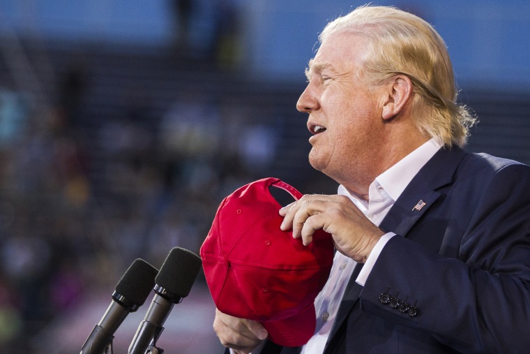 U.S. Republican presidential candidate Donald Trump removes his hat at Ladd-Peebles Stadium on August 21, 2015 in Mobile, Alabama. (Photo by Mark Wallheiser/Getty)