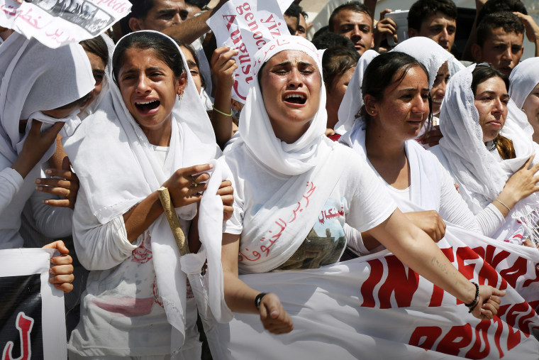 Yazidi Kurdish women chant slogans during a protest against the Islamic State in Dohuk, northern Iraq, Aug. 3, 2015. (Photo by Seivan M. Salim/AP)