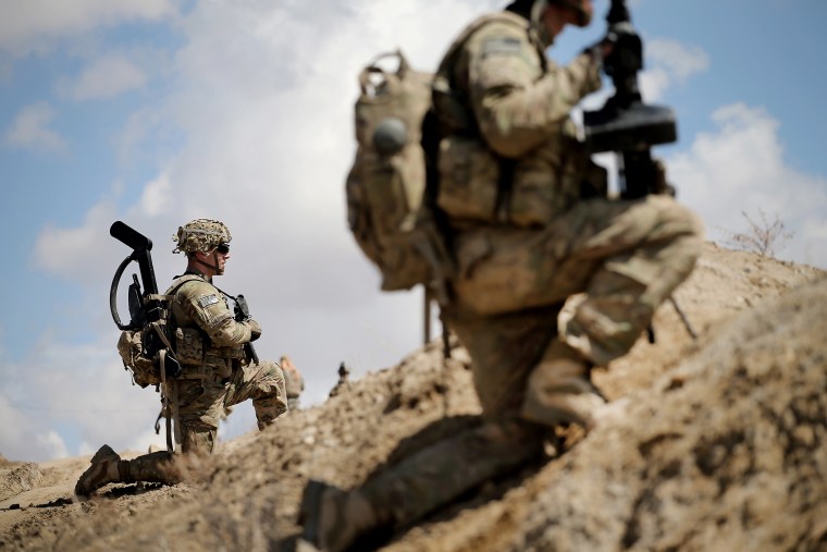 Sgt. Nathan Harrell with the U.S. Army's 2nd Battalion 87th Infantry Regiment, 3rd Brigade Combat Team, 10th Mountain Division, patrols on the edge of a village near Pul-e Alam, Afghanistan on March 29, 2014. (Photo by Scott Olson/Getty)