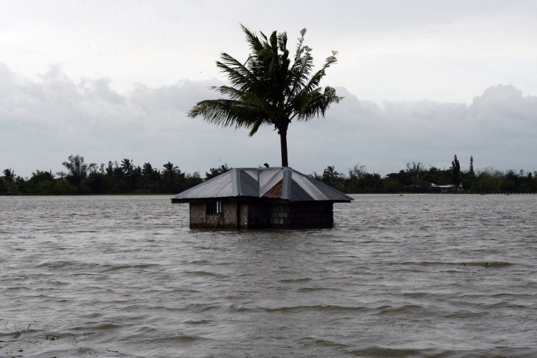 An inundated house is seen amid floodwaters in Santa Rosa town, Nueva Ecija province, north of Manila on Oct. 19, 2015, a day after typhoon Koppu hit Aurora province. (Photo by Ted Aljibe/AFP/Getty)