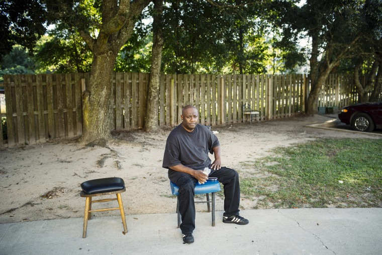 Joseph Anderson, 52, sits and waits for his girlfriend Qumotria Kennedy to get off work in the parking lot of the apartment complex where he lives in Biloxi. (Photo by William Widmer/ACLU)