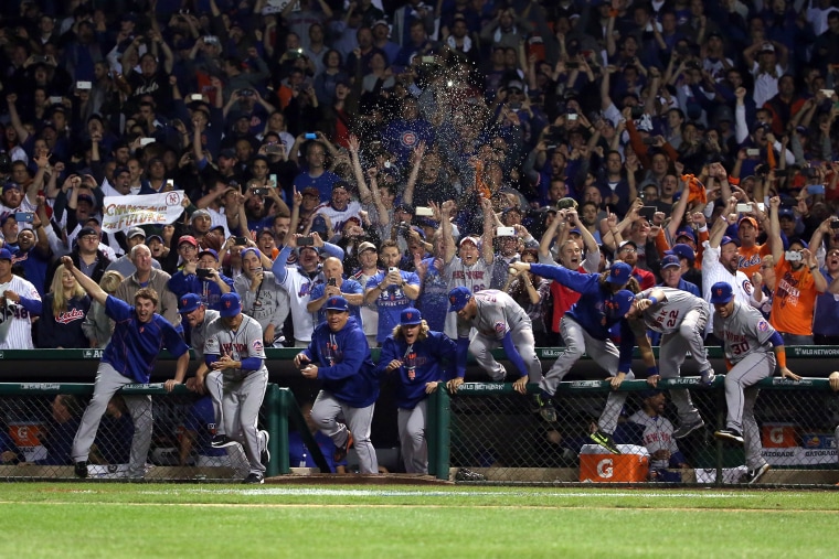 The New York Mets dugout rushes the field to celebrate with his team after defeating the Chicago Cubs in game four of the 2015 MLB National League Championship Series at Wrigley Field on Oct. 21, 2015 in Chicago, Ill. (Photo by Jonathan Daniel/Getty)