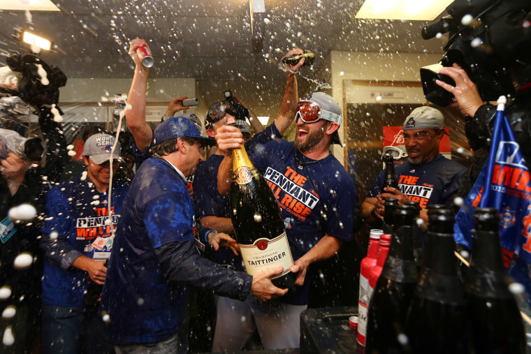 New York Mets players celebrate after Game 4 of the National League baseball championship series against the Chicago Cubs, Oct. 21, 2015, in Chicago. (Photo by Elsa/Pool/AP)