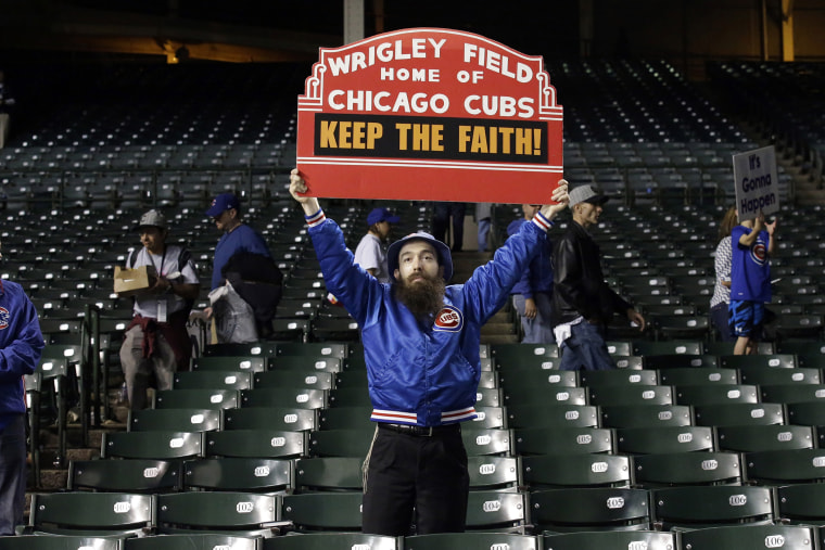A Chicago Cubs fan holds up a sign after Game 4 of the National League baseball championship series against the New York Mets, Oct. 21, 2015, in Chicago. (Photo by Nam Y. Huh/AP)