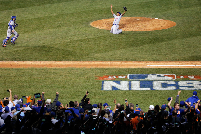 Jeurys Familia #27 and Travis d'Arnaud #7 of the New York Mets celebrate after defeating the Chicago Cubs in game four of the 2015 MLB National League Championship Series at Wrigley Field on Oct. 21, 2015 in Chicago, Ill. (Photo by Jon Durr/Getty)