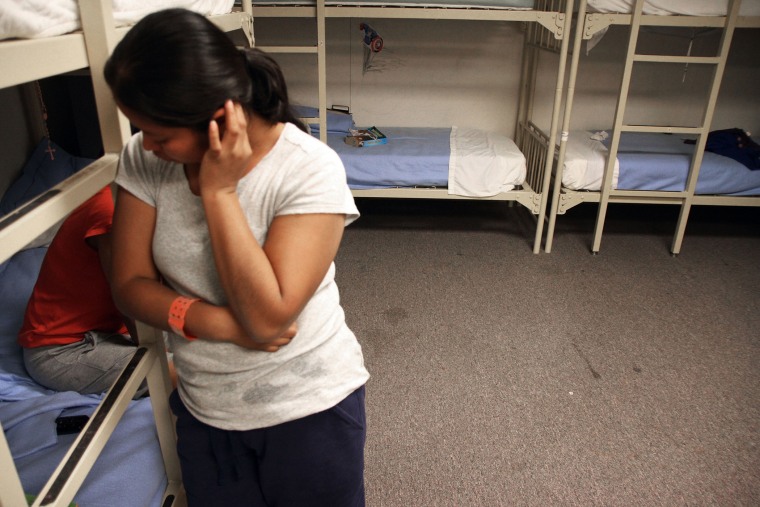 An unidentified Guatemalan woman is seen inside a dormitory in the Artesia Family Residential Center, a federal detention facility for undocumented immigrant mothers and children in Artesia, N.M, Sept. 10, 2014. (Photo by Juan Carlos Llorca/AP)