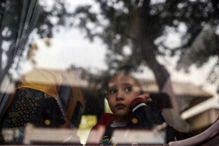 A refugee child looks through a bus window as they leave for Istanbul, abandoning plans to cross to Europe near Turkey's western border with Greece and Bulgaria, in Edirne, Turkey, Sept. 23, 2015. (Photo by Emrah Gurel/AP)