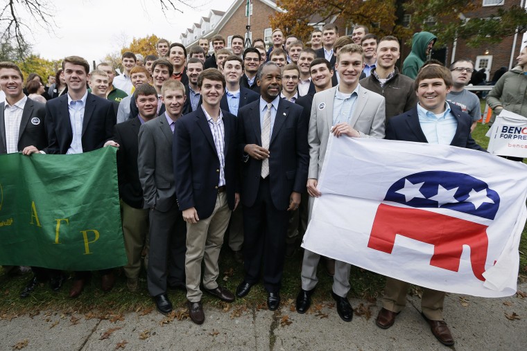 Republican presidential candidate Dr. Ben Carson poses for a photo with Alpha Gamma Rho fraternity members at Iowa State University following a campaign stop, Oct. 24, 2015, in Ames, Iowa. (Photo by Charlie Neibergall/AP)