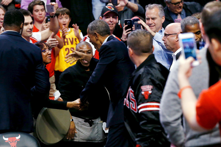 U.S. President Barack Obama greets fans as he attends an NBA opening night game between the Cleveland Cavaliers and the Chicago Bulls in Chicago, Oct. 27, 2015. (Photo by Jonathan Ernst/Reuters)