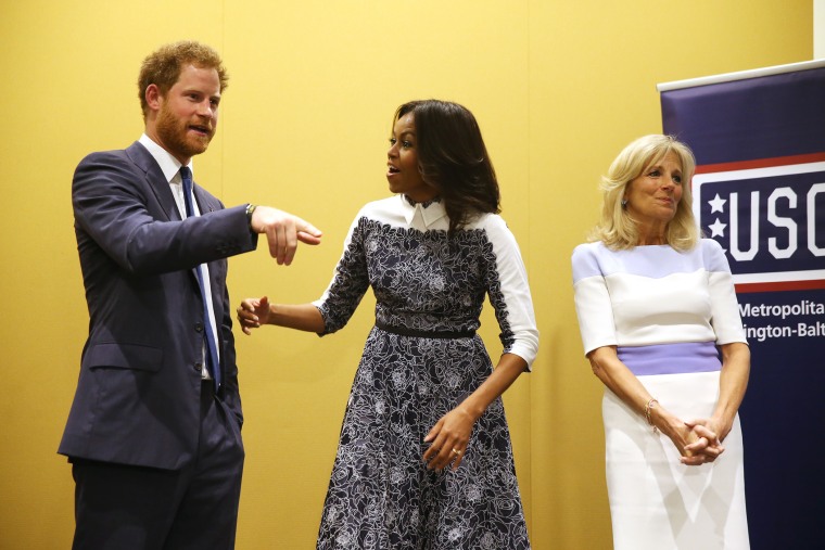 Britain's Prince Harry, first lady Michelle Obama and Jill Biden tour the USO Warrior and Family Center at the Fort Belvoir military base, Oct. 28, 2015, at Fort Belvoir, Va. (Photo by Andrew Harnik/AP)