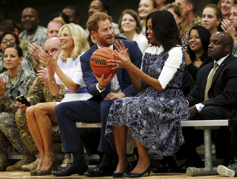 Britain's Prince Harry hands U.S. first lady Michelle Obama the basketball at the end of a game played by wounded warriors at Fort Belvoir, Va, Oct. 28, 2015. (Photo by Kevin Lamarque/Reuters)