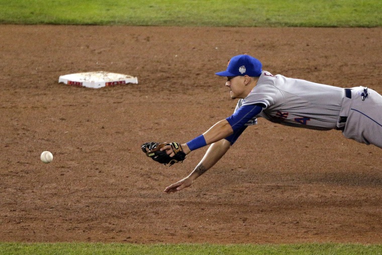New York Mets shortstop Wilmer Flores unsuccessfully reaches for a Kansas City Royals' Eric Hosmer two-RBI single during the fifth inning of Game 2 of the MLB World Series, Oct. 28, 2015, in Kansas City, Mo. (Photo by Charlie Riedel/AP)