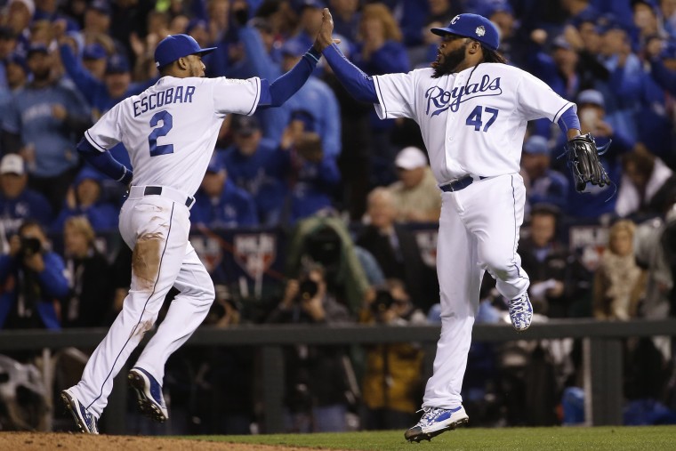 Kansas City Royals pitcher Johnny Cueto (47) celebrates with Alcides Escobar during Game 2 of the Major League Baseball World Series against the New York Mets, Oct. 28, 2015, in Kansas City, Mo. (Photo by Matt Slocum/AP)
