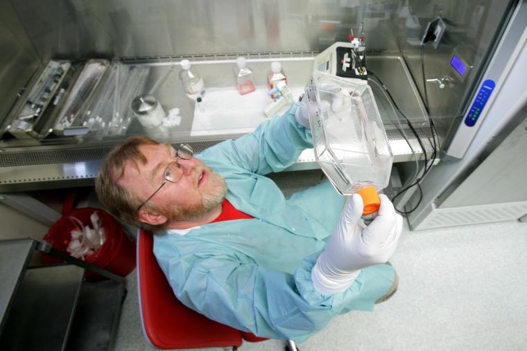 Lab technician Butch Wrobel harvests cell samples from a tissue culture at the Alaska State Virology Lab, June 12, 2009, which is helping health officials track disease like herpes, HIV, rabies and swine flu. (Photo by Eric Engman/Fairbanks Daily News/AP)