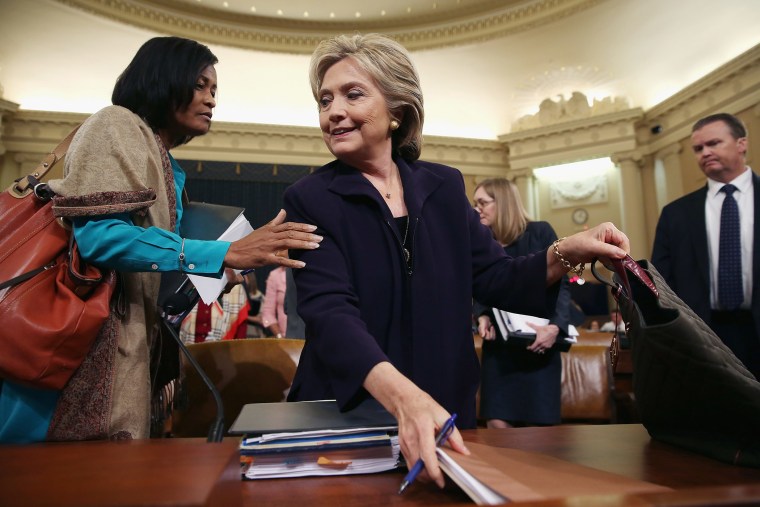 Hillary Clinton and Former State Department Chief of Staff Cheryl Mills take a break in a hearing of the House Select Committee on Benghazi Oct. 22, 2015 on Capitol Hill in Washington, DC. (Photo by Chip Somodevilla/Getty)