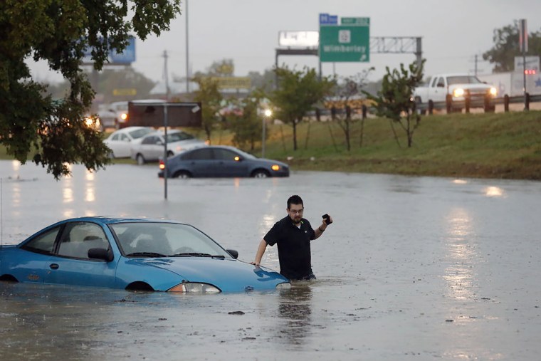 Mike Stoner gets out of his flooded car, Friday, Oct. 30, 2015 in San Marcos, Texas. (Photo by Rodolfo Gonzalez/Austin American-Statesman/AP)