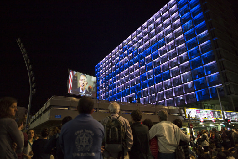 Israelis listen to a video message by U.S. President Barack Obama as they take part in a rally commemorating the 20th anniversary of the assassination of late prime minister Yitzhak Rabin in Tel Aviv, Israel, Oct. 31, 2015. (Photo by Amir Cohen/Reuters)