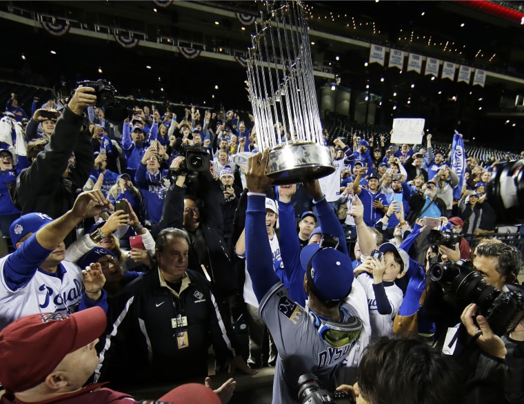 Kansas City Royals' Jarrod Dyson holds the World Series trophy after Game 5 of the Major League Baseball World Series against the New York Mets, Nov. 2, 2015, in New York, N.Y. (Photo by Matt Slocum/AP)