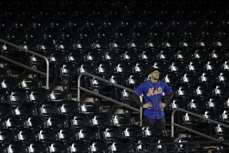 A New York Mets fan watches as the Kansas City Royals celebrates after Game 5 of the Major League Baseball World Series, Nov. 2, 2015, in New York. (Photo by Julie Jacobson/AP)