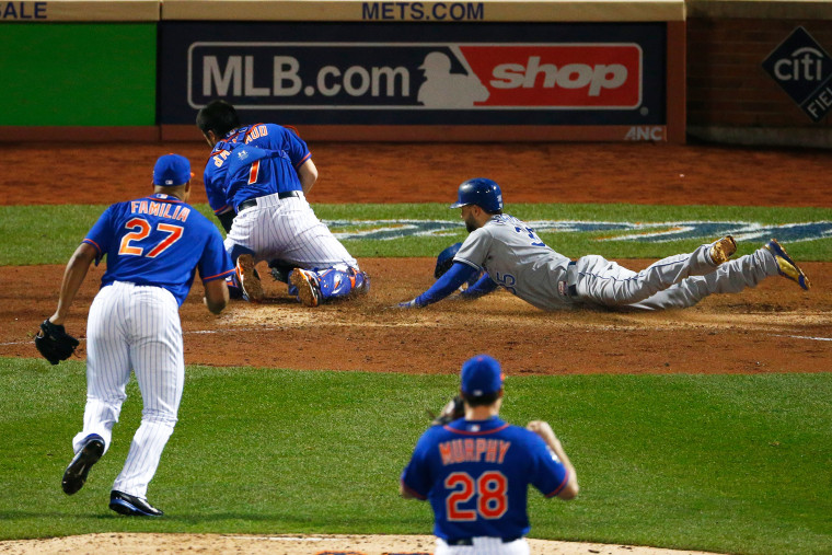 Eric Hosmer #35 of the Kansas City Royals scores a run off of a grounded out hit by Salvador Perez #13 (not pictured) to tie the game in the ninth inning against Jeurys Familia #27 of the New York Mets during Game Five (Photo by Mike Stobe/Getty)