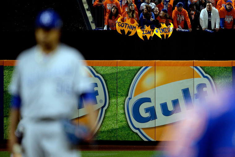 New York Mets fans hold signs in the first inning during Game Five of the 2015 World Series between the Kansas City Royals and the New York Mets at Citi Field on Nov. 1, 2015 in New York, N.Y.