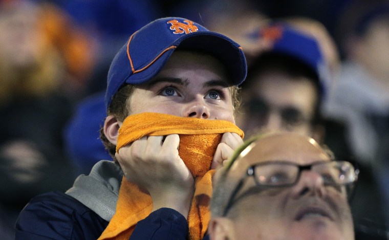 New York Mets fans watch during the 12th inning of Game 5 of the Major League Baseball World Series against the Kansas City Royals, Nov. 2, 2015, in New York. (Photo by Peter Morgan/AP)