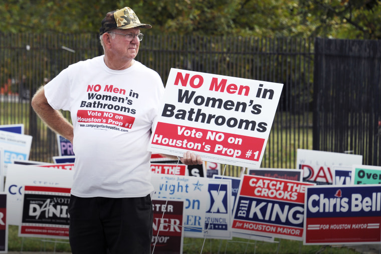 In this Oct. 21, 2015 file photo, a man urges people to vote against the Houston Equal Rights Ordinance outside an early voting center in Houston. (Photo by Pat Sullivan/AP)