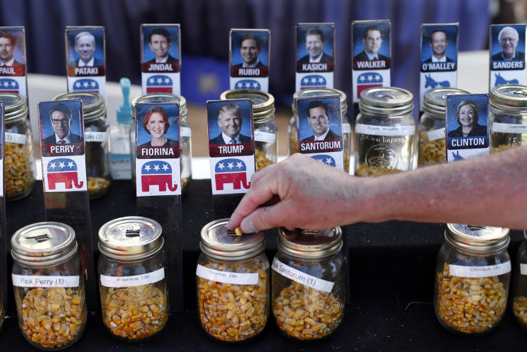 A visitor casts their vote with a kernel of corn for presidential candidate Donald Trump in a straw poll at the Iowa State Fair, Aug. 20, 2015, in Des Moines, Iowa. (Photo by Paul Sancya/AP)
