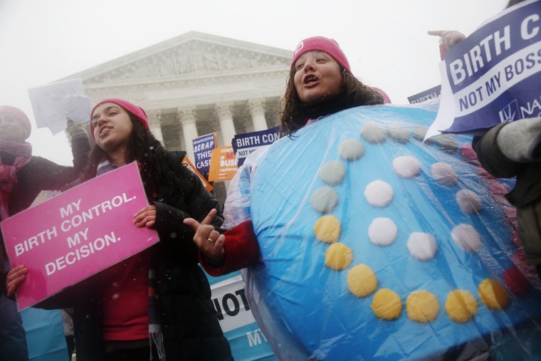 Citizens protest in front of the Supreme Court in Washington as the court heard oral arguments challenging a health care law's regulations regarding contraceptives, March 25, 2015. (Photo by Charles Dharapak/AP)