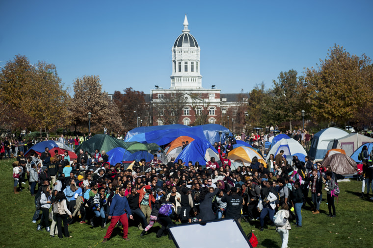 Supporters of Concerned Student 1950 celebrate following University of Missouri System President Tim Wolfe's resignation announcement, Nov. 9, 2015, at the protest movement's camp area in Columbia, Mo. (Photo by Nick Schnelle/Columbia Daily Tribune/AP)