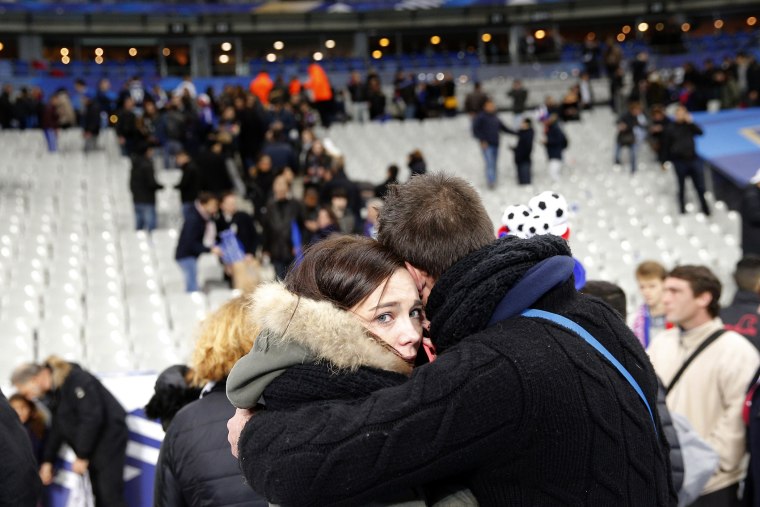 A supporter comforts a friend after invading the pitch of the Stade de France stadium at the end of the international friendly soccer match between France and Germany in Saint Denis, outside Paris, Nov. 13, 2015. (Photo by Christophe Ena/AP)