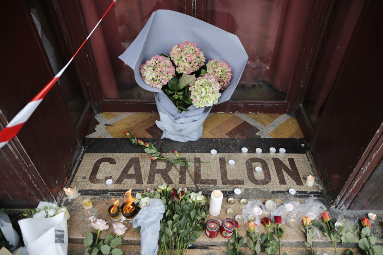 Flowers are seen placed on the doorstep of the Le Carillon restaurant the morning after a series of deadly attacks in Paris, Nov. 14, 2015. (Photo by Christian Hartman/Reuters)