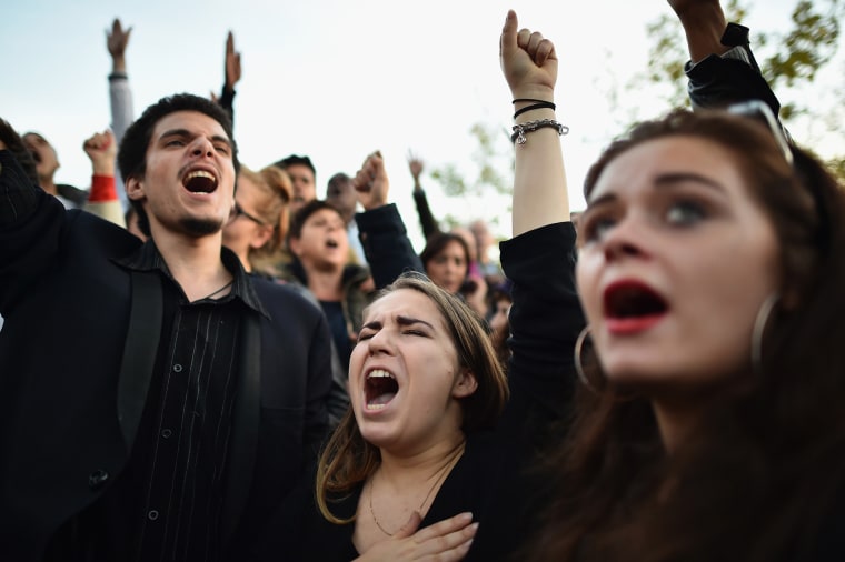 People sing the French national anthem at Place de la Republique as France observes three days of national mourning for the victims of the terror attacks on Nov. 15, 2015 in Paris, France. (Photo by Jeff J Mitchell/Getty)