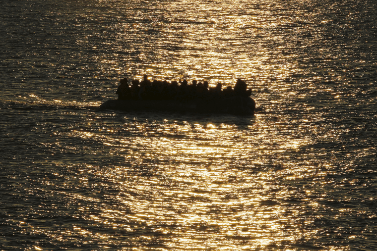 A raft overcrowded with migrants and refugees approaches a beach at dawn on the Greek island of Lesbos Nov. 17, 2015. (Photo by Yannis Behrakis/Reuters)