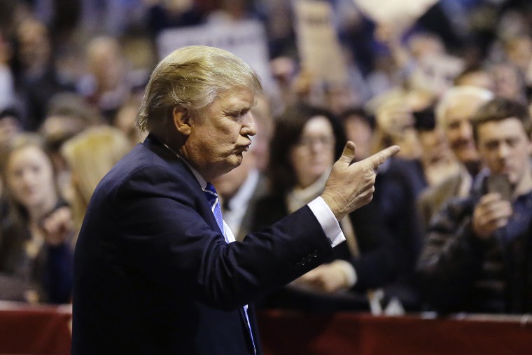 Republican presidential candidate Donald Trump gestures toward the audience before signing autographs at the conclusion of a campaign event, Nov. 18, 2015, in Worcester, Mass. (Photo by Steven Senne/AP)