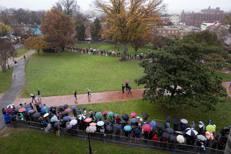 Students and others lineup in the rain on Healy Lawn at Georgetown University in Washington, Nov. 19, 2015, to hear Democratic presidential candidate Sen. Bernie Sanders speak. (Photo by Carolyn Kaster/AP)