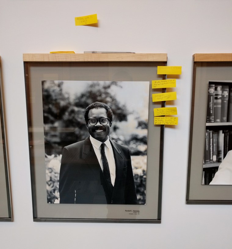 After black tape defacing Harvard Law School faculty members was removed, students added post-it notes with positive statements, seen here, such as \"Randy Kennedy is one of the best professors I’ve ever had!\" (Photo by Kendra Albert)