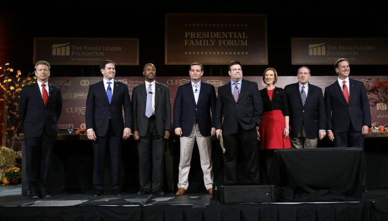 Republican presidential candidates, from left, Rand Paul, Marco Rubio, Ben Carson, Ted Cruz, moderator Frank Luntz, Carly Fiorina, Mike Huckabee and Rick Santorum stand on stage during the Presidential Family Forum, Friday, Nov. 20, 2015, in Des Moines, I