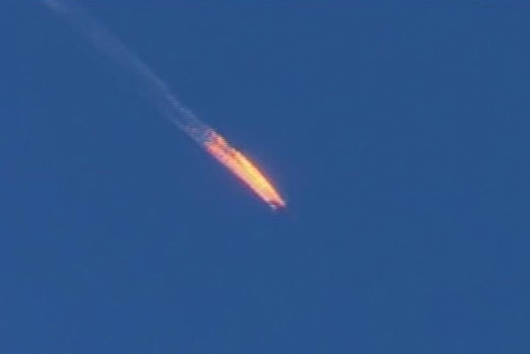 This frame grab from video by Haberturk TV, shows a Russian warplane on fire before crashing on a hill as seen from Hatay province, Turkey, Nov. 24, 2015. (Photo by Haberturk TV/AP)