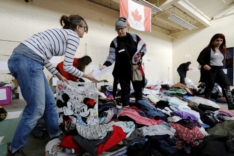 Clothing donated for an expected influx of Syrian refugees is sorted by volunteers for size and gender at a theatre rehearsal space in Toronto, Canada, Nov. 24, 2015. (Photo by Chris Helgren/Reuters)