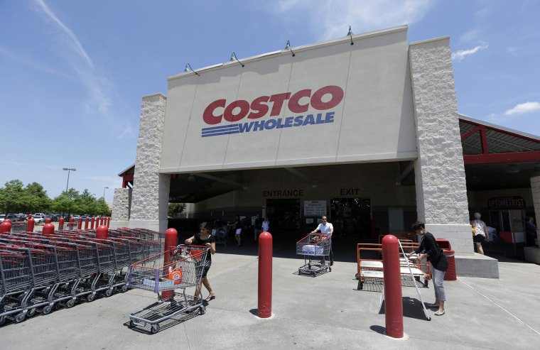 Shoppers push carts out of a Costco in Plano, Texas, June 4, 2014. (Photo by LM Otero/AP)