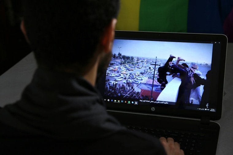 In this Oct. 22, 2015, photo, Daniel Halaby shows a photo from his laptop of Islamic State group militants throwing a man off a roof for allegedly violating the extremists' ban on homosexuality. (Photo by Hussein Malla/AP)