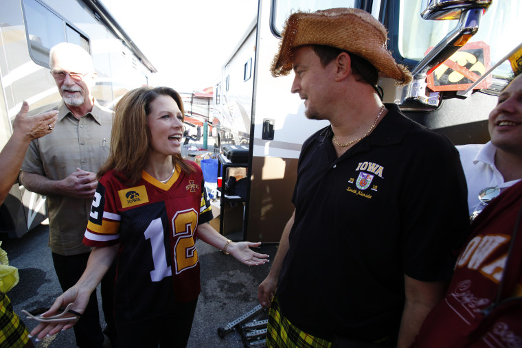 Former U.S. Rep. Michele Bachmann talks with Mark Chelgren of Ottumwa, Iowa, while tailgating before an NCAA college football game between Iowa State and Iowa, Sept. 10, 2011, in Ames, Iowa. (Photo by Charlie Neibergall/AP)